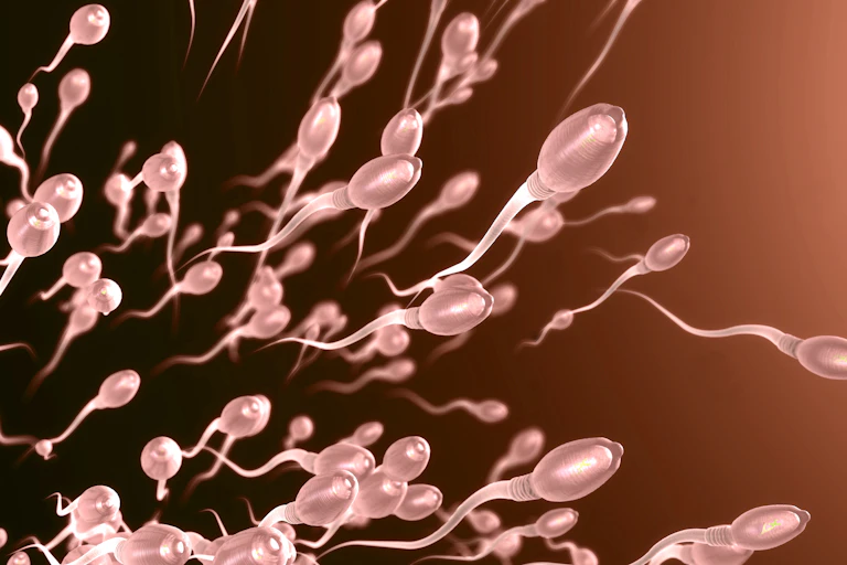 a 3D illustration of sperm swimming toward the right
