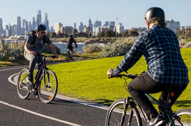 People ride along a bike path in Melbourne.