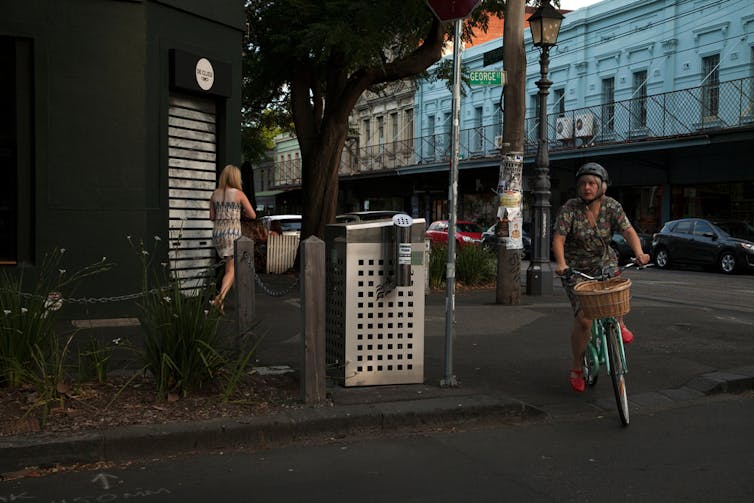 A woman cycles on the street.