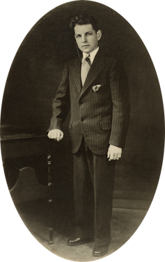 Black and white portrait of a boy in a suit.