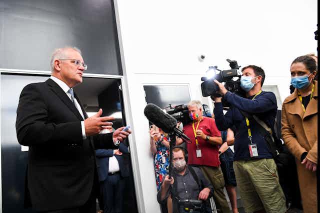 Scott Morrison address the media