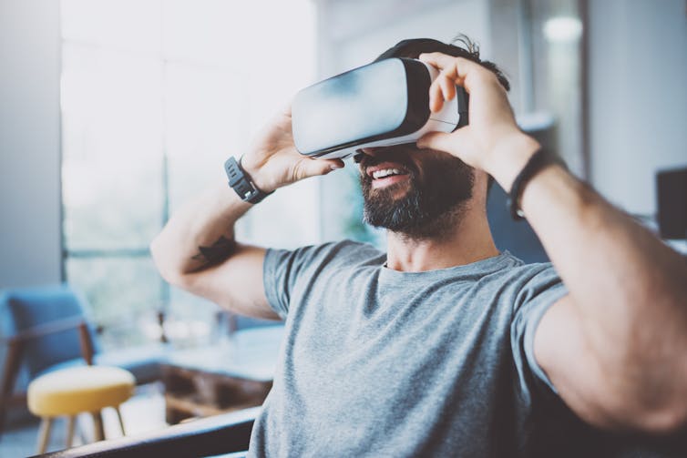 A man uses virtual reality glasses.