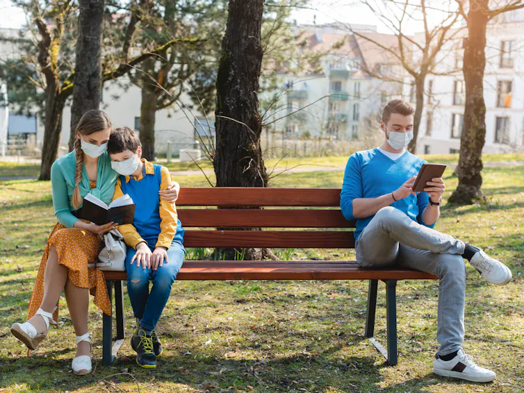 image of people sitting on a bench, socially distancing.