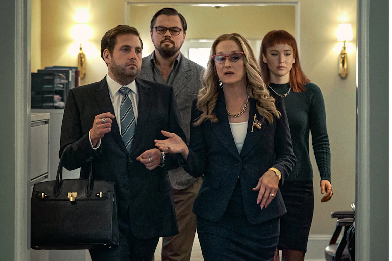 Four people walk through corridor