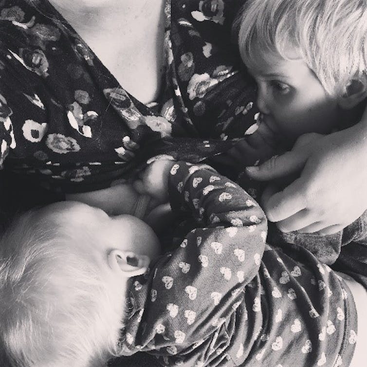 Two children breastfeeding