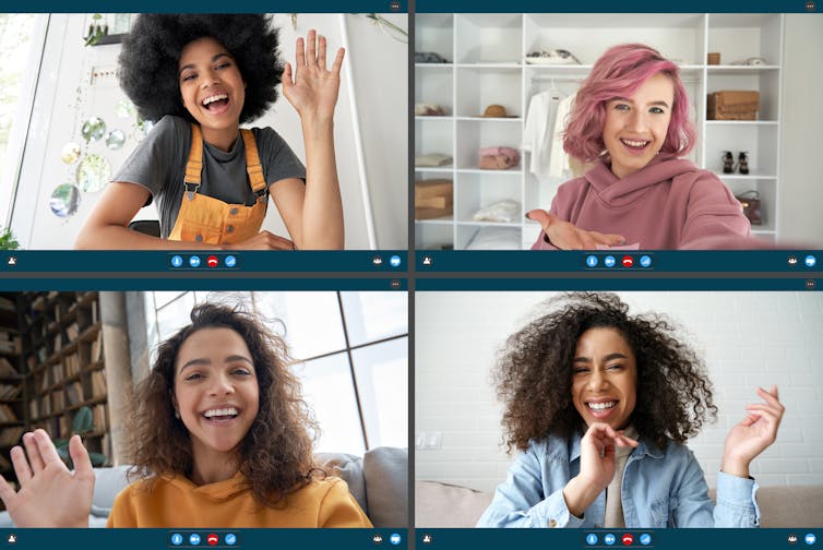 Four female friends greeting each other on an online video call.