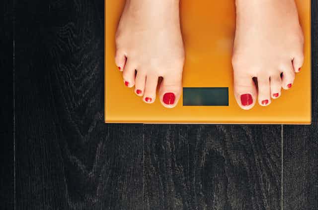 Person's feet on a bathroom scale