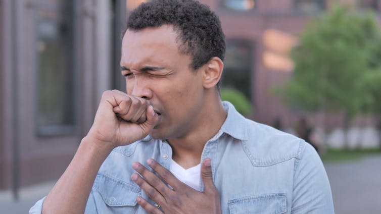 A man coughing