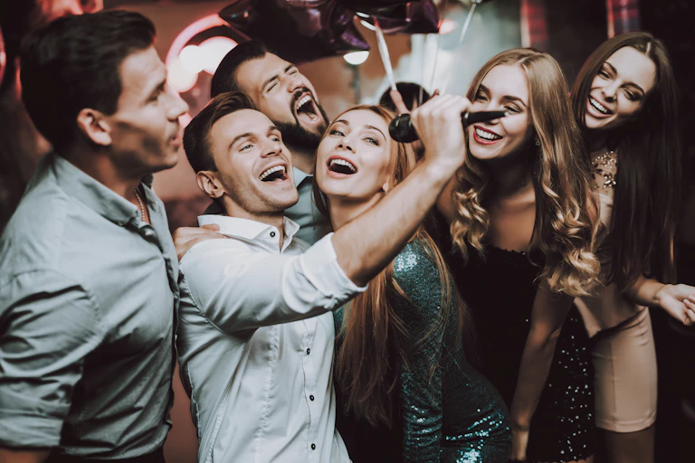 Unmasked people close together singing