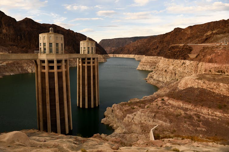 Image of Lake Mead shows intake towers far above the water level and light rock around edges indicate low water.