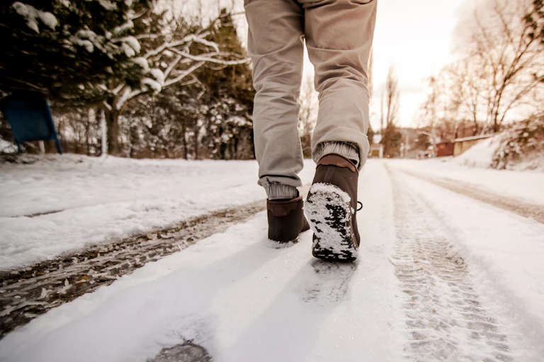 Footprints seen on a snowy road.
