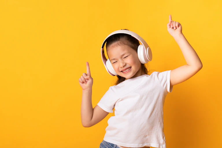 A girl in headphones is dancing with eyes closed.