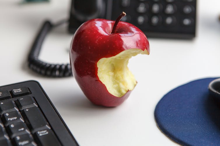 An apple with a bite taken out of it.