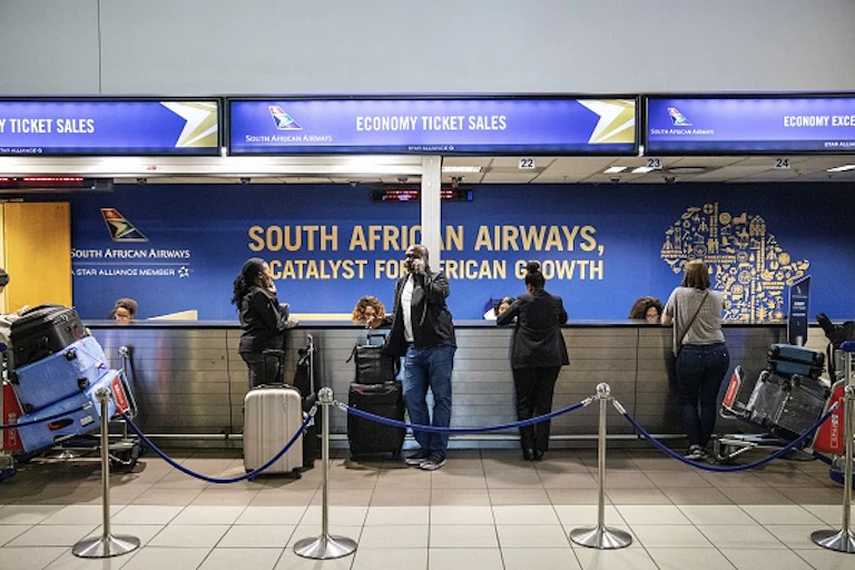 Travellers queuing at airport counter