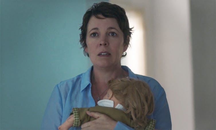 Woman carrying a doll