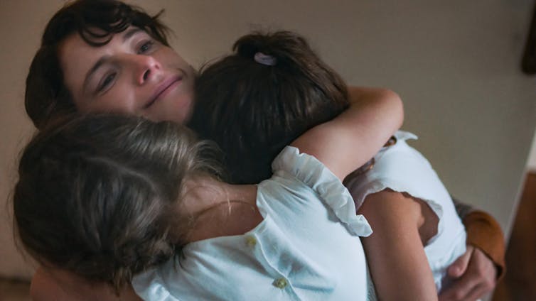 Woman hugging children
