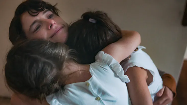 Woman hugging children