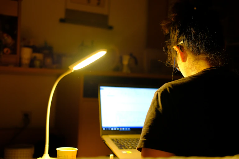 Student working late at computer.