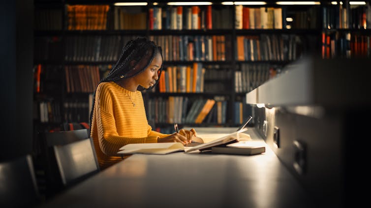 Young woman in dark at library