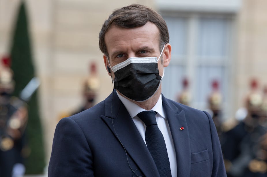 Emmanuel Macron wearing a black mask