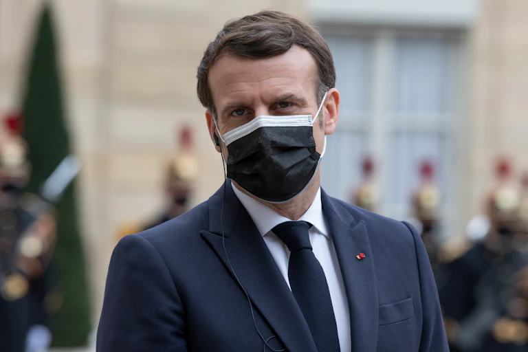 Emmanuel Macron wearing a black mask