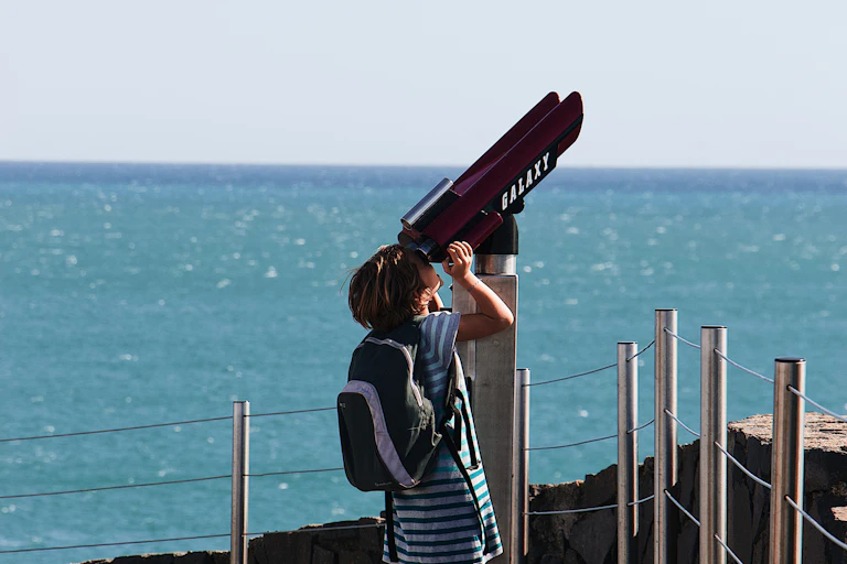 Girl looking through telescope
