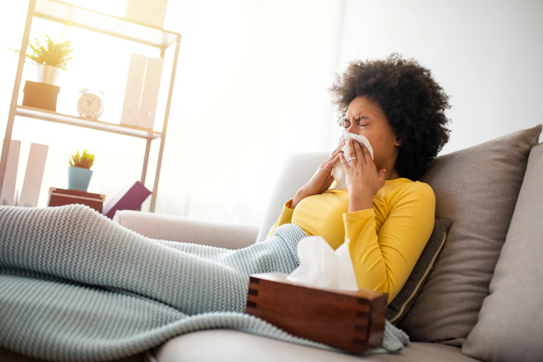 A woman blowing her nose