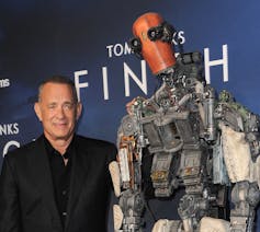 Tom Hanks shown with a robot.