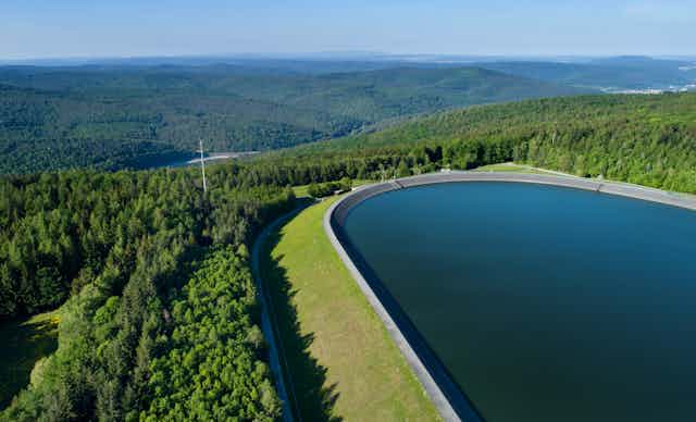 View across a mountaintop reservoir to another below.