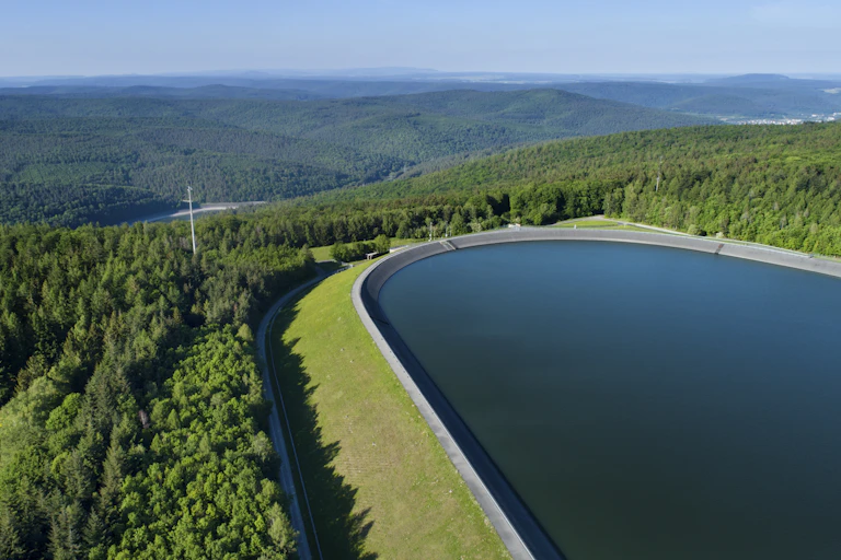 View across a mountaintop reservoir to another below.