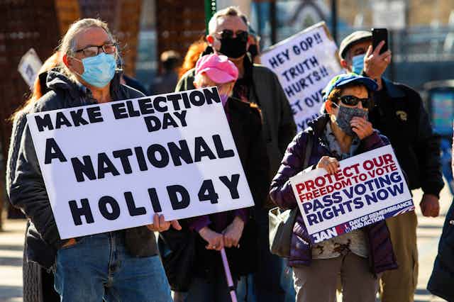 Protesters with signs advocating voting rights.
