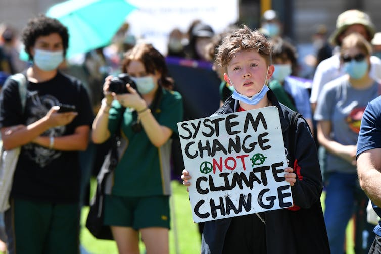 boy holds sign