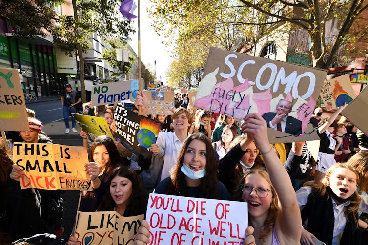 students walk and yello at protest