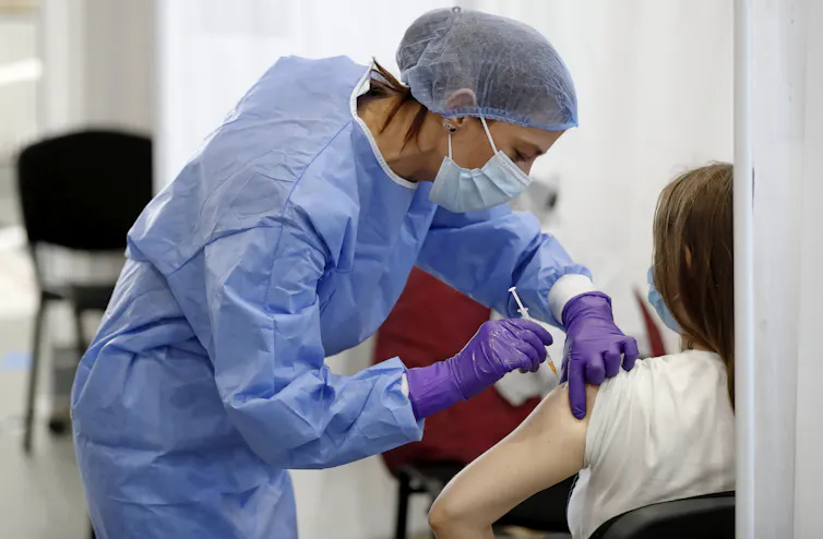 A person being vaccinated against COVID