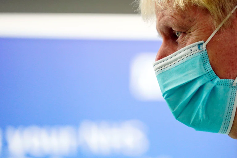Boris Johnson in profile wearing a covid mask