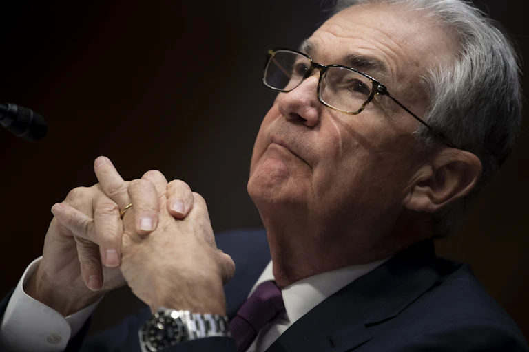 Fed Chair Jerome Powell looking up with his hands together