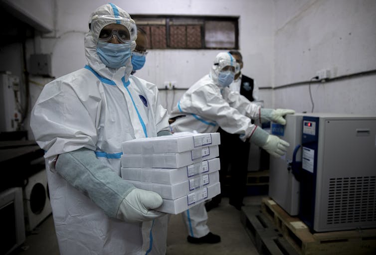Staff storing Covax-donated vaccines in Nepal
