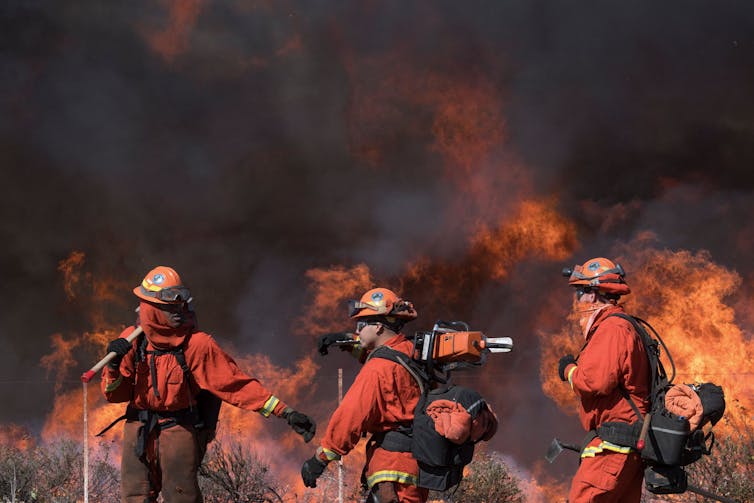 Inmates fighting a fire.