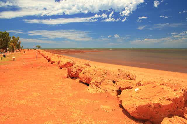 red earth foreshore and ocean