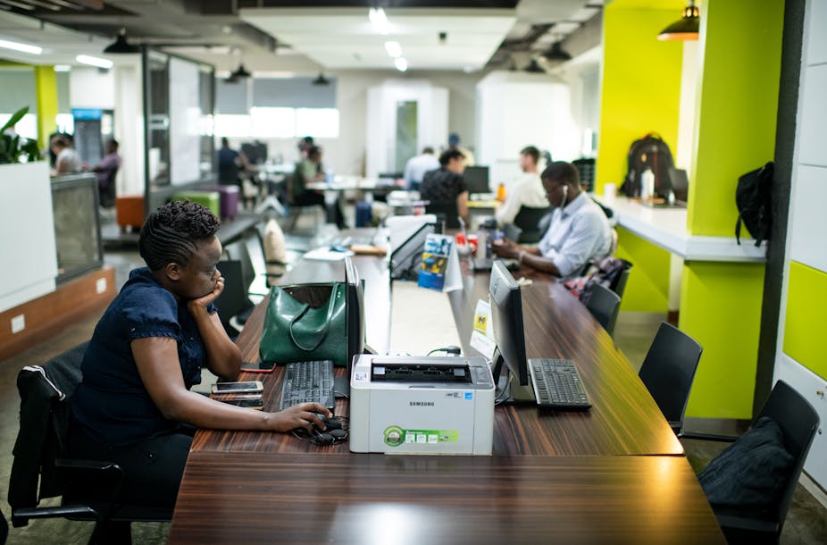 IT specialists sit at computers in the iHub, an innovation centre for technology companies, Nairobi, Kenya. 