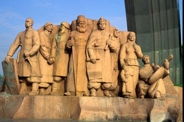 Sandstone statue from Kyiv, Ukraine showing important male historial figures from Russia and Ukraine.