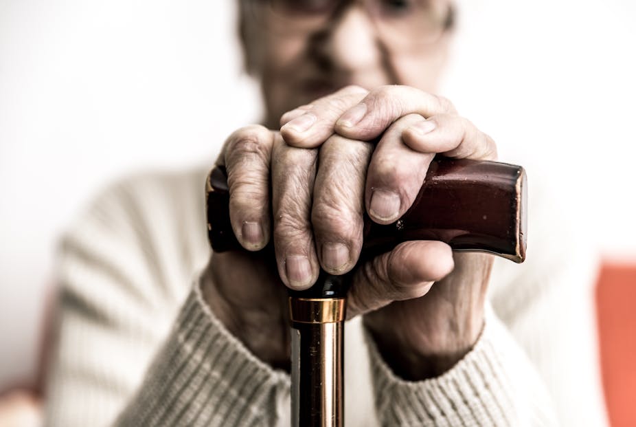 Older person holding their cane.