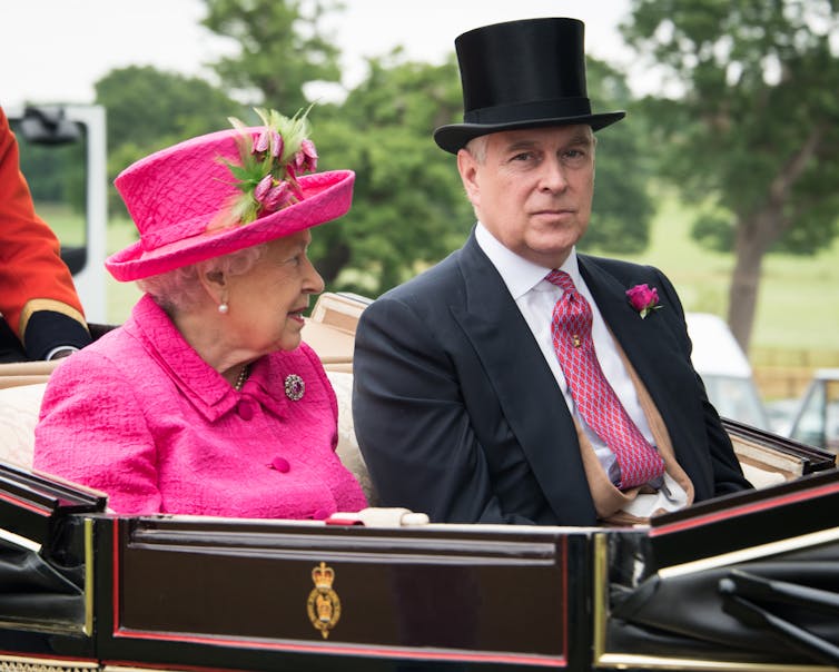 Prince Andrew and the Queen in formal dress heading to Royal Ascot in an open top carriage