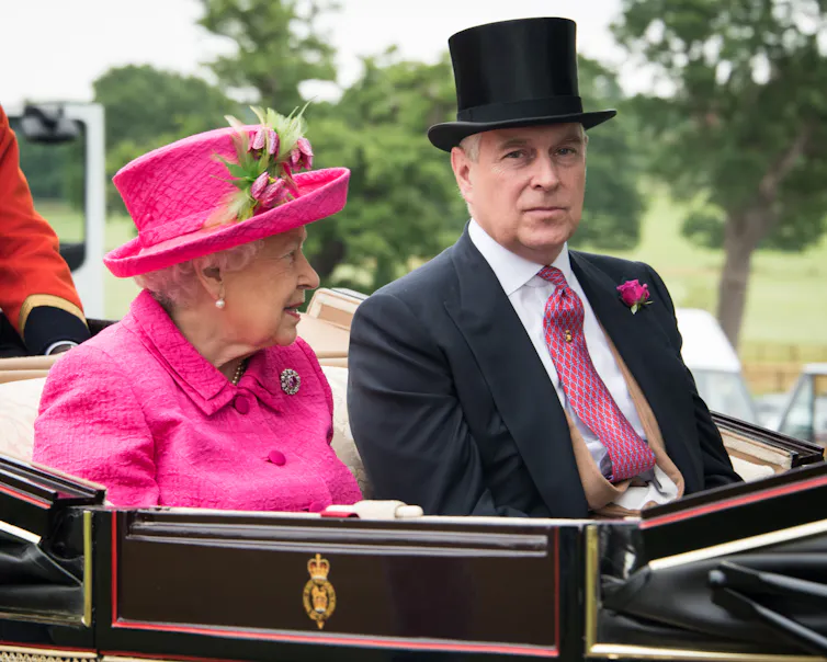Prince Andrew and the Queen in formal dress heading to Royal Ascot in an open top carriage