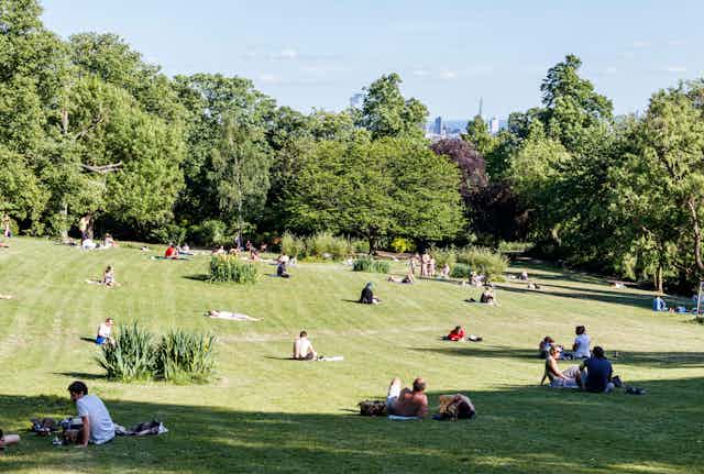 People spread out to socially distance in a London park during the lockdown of May 2020.