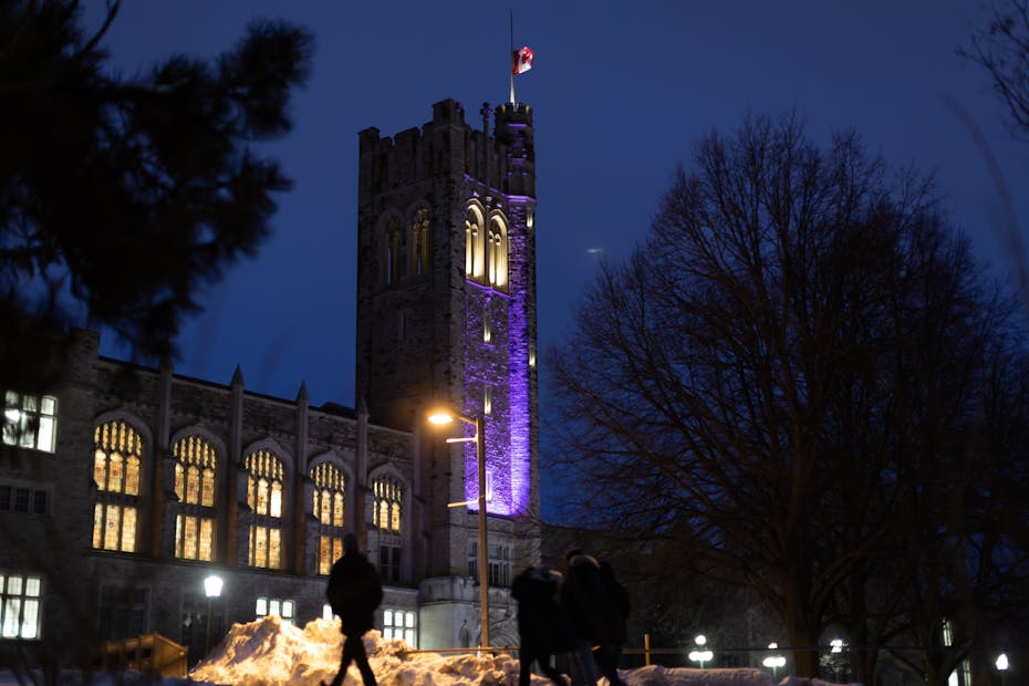 A university is seen in the winter at night.