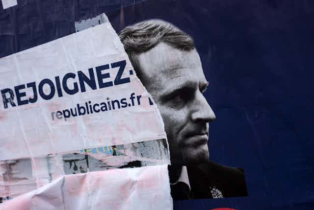 A poster for Les Republicains on top of a poster of Emmanuel Macron.