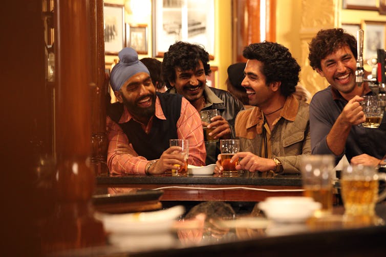 Four Indian men at a pub.