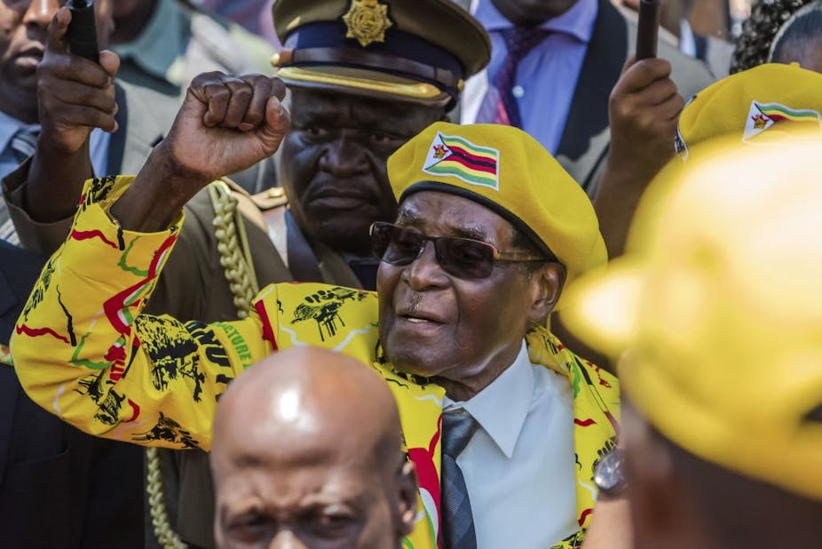 Zimbabwe's President Robert Mugabe surrounded by his supporters