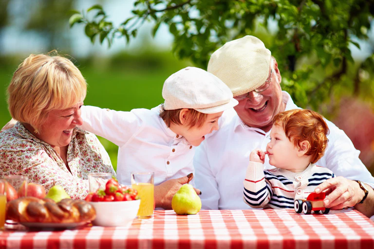 grandparents and two kids at table